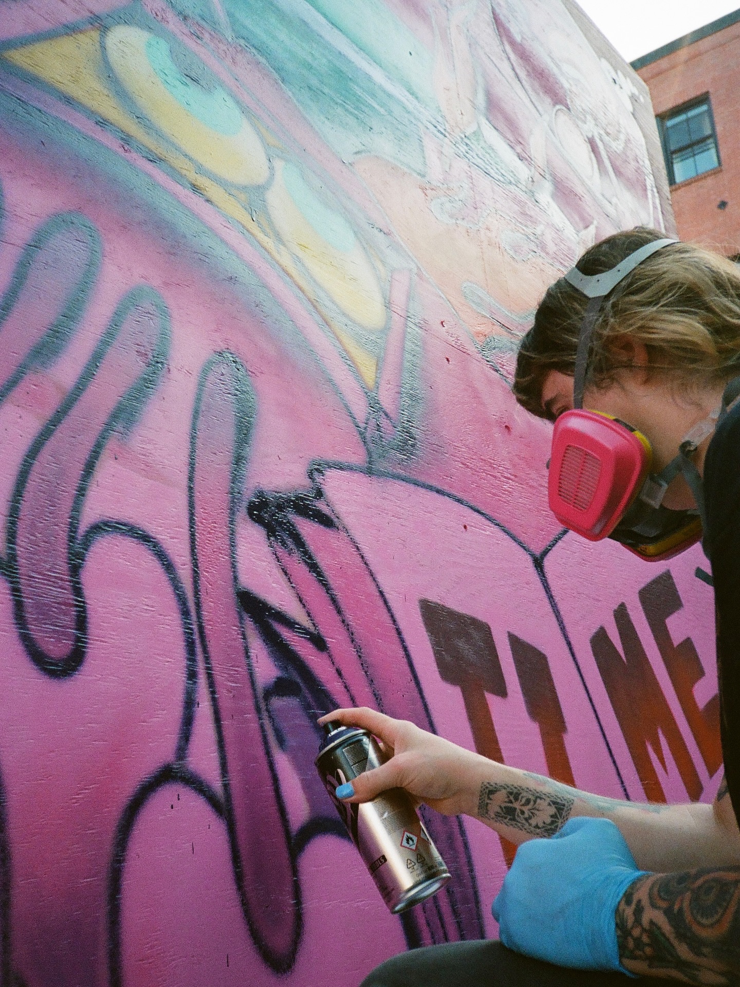 Artist at Cobble to Cobble mural